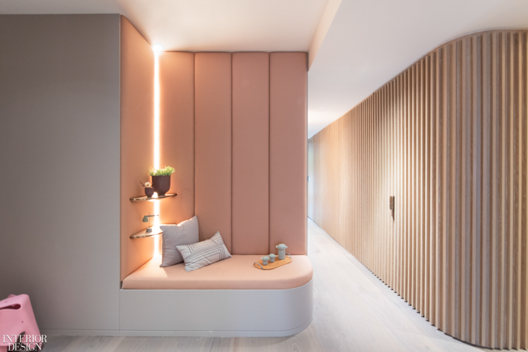 a timber-slat hallway across from a bench seat in a home