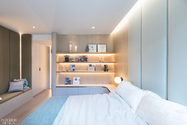 a minimalist bedroom with under-shelf lighting on one wall