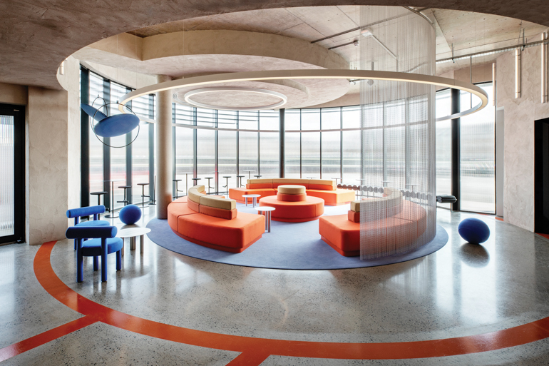 orange modular sofas in the center of a lounge space at Sonica's Dublin headquarters