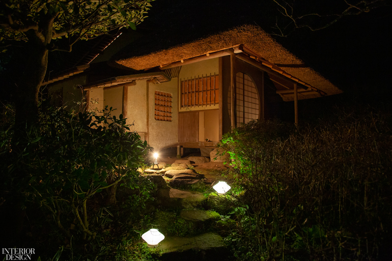 a Japanese tea house lit up at night