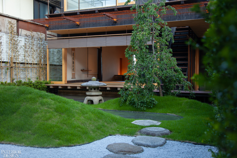 a zen garden at the entrance to a guest house