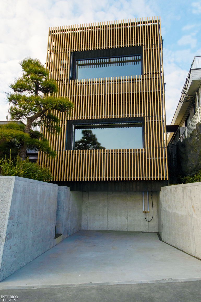 wood panels line the exterior of a guest house facing the beach