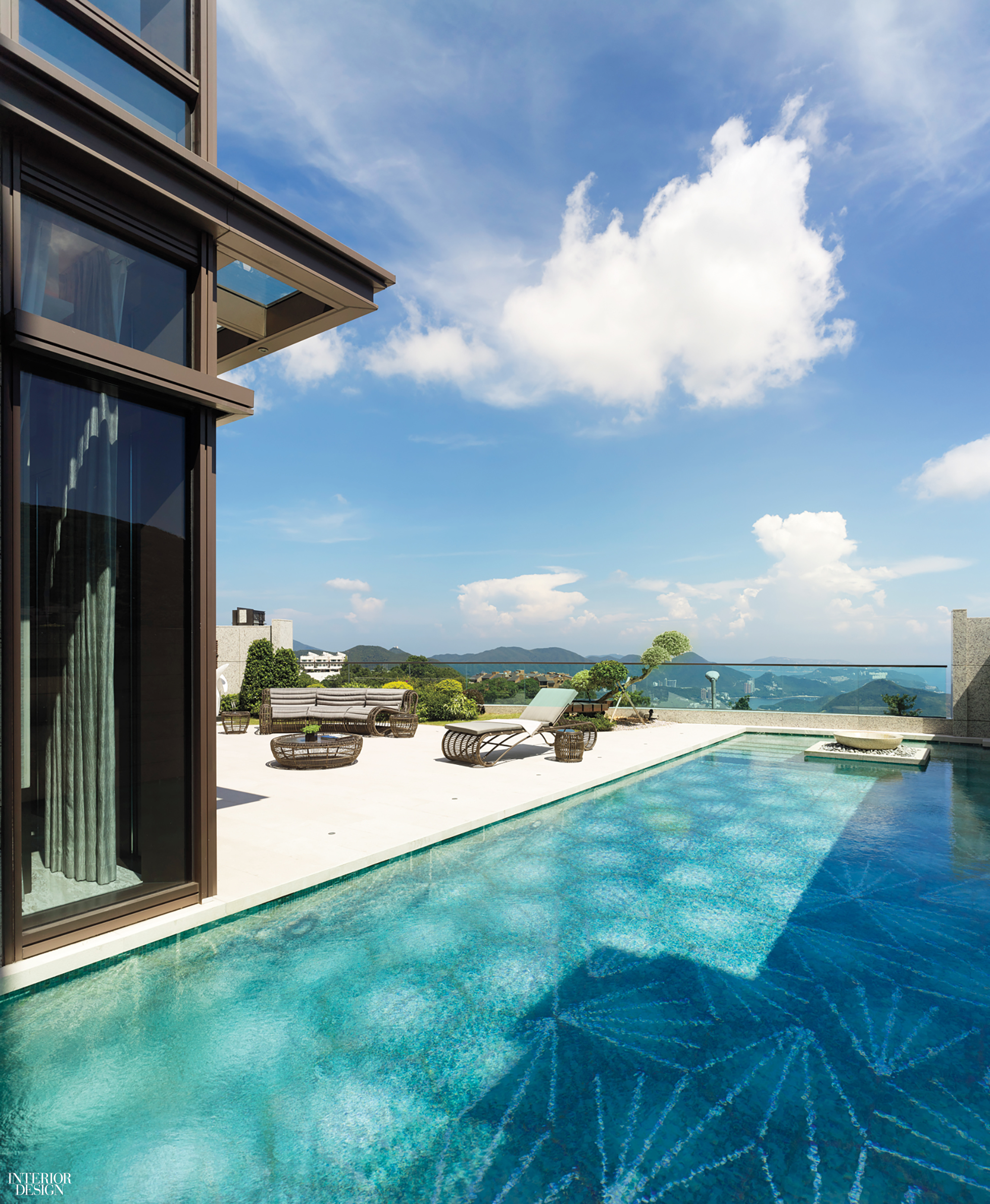 a rooftop pool in hone kong with a design in the tiled floor