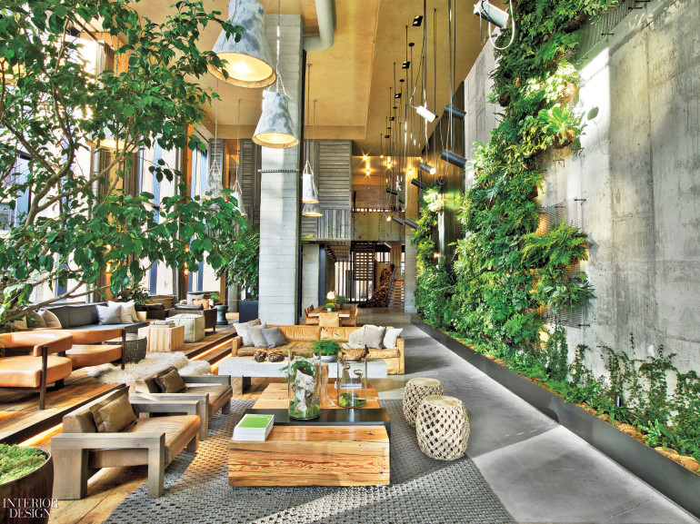 Wood and stone elements are offset by lush greenery in this hotel lobby. 