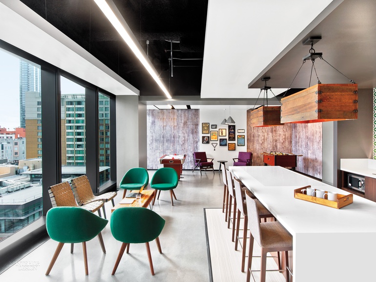 the office kitchen in LinkedIn's San Francisco office with green velvet seating and a photo collage on the back wall 