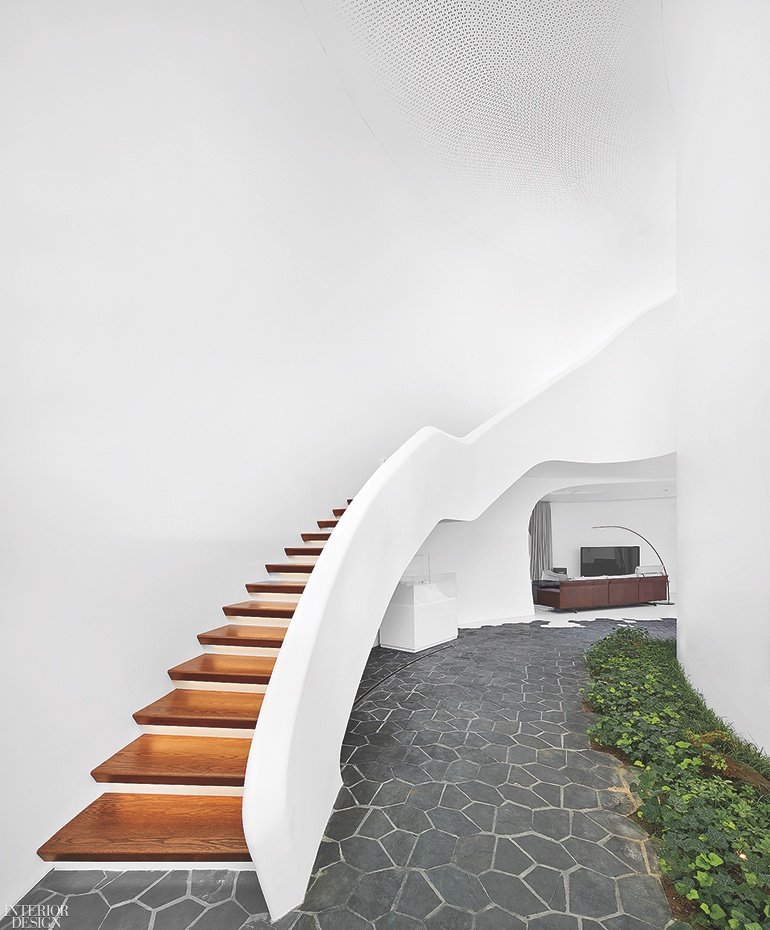 Wooden steps seem to float in this white stairwell. 